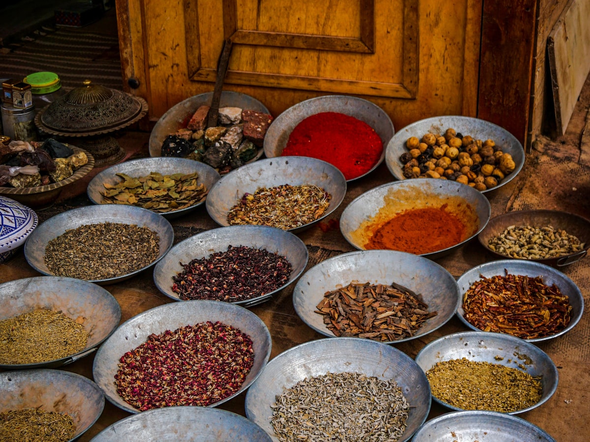 Assortment of premium Indian spices in traditional market bowls